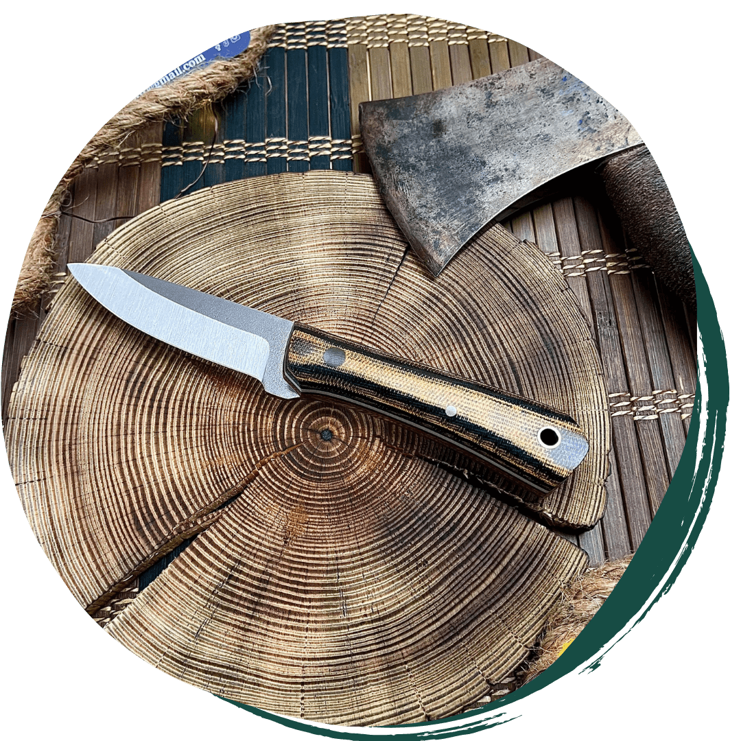 handmade knife sitting atop of a log